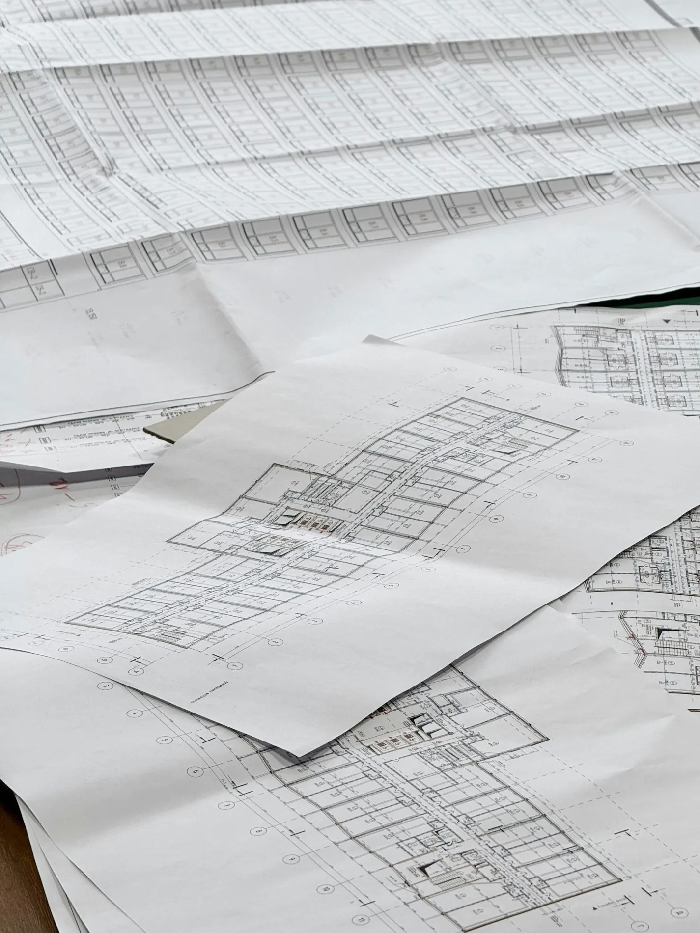 Technical drawings spread flat across a table