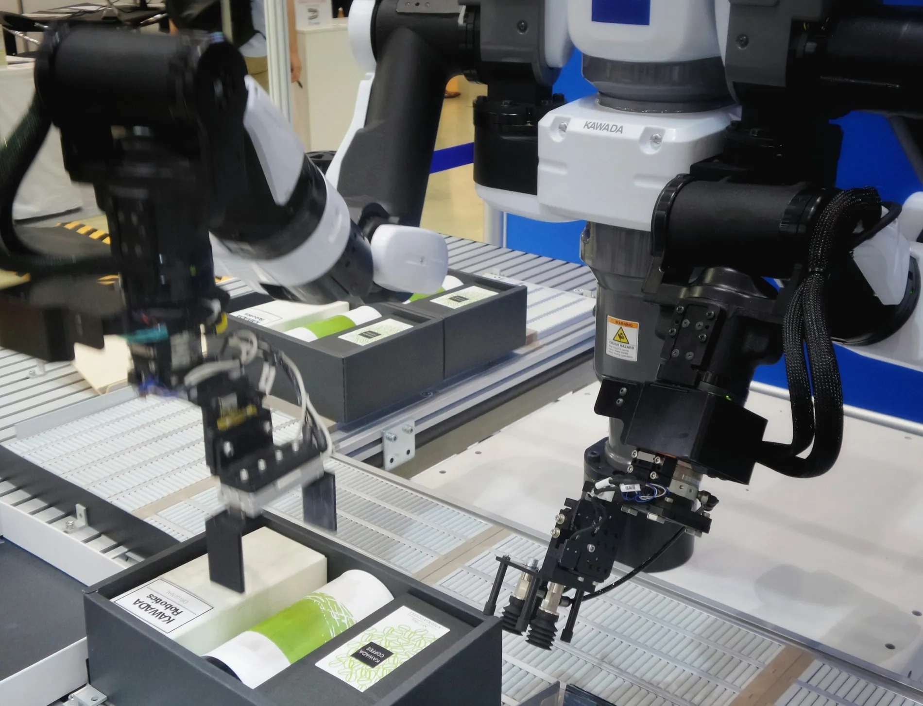 A robot arm lifting a printed sheet off a line