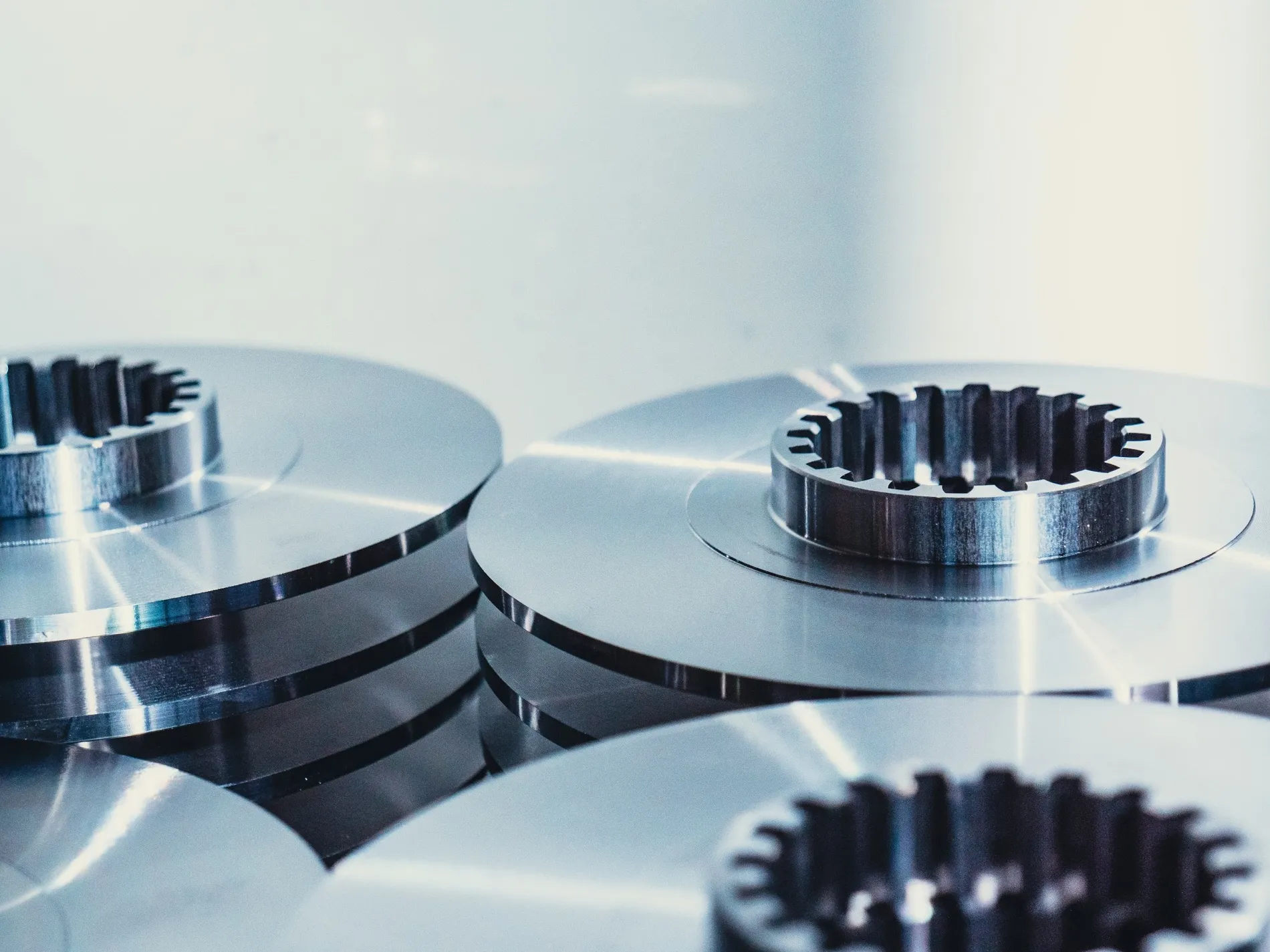 Machined discs with cut teeth, stacked on the bench
