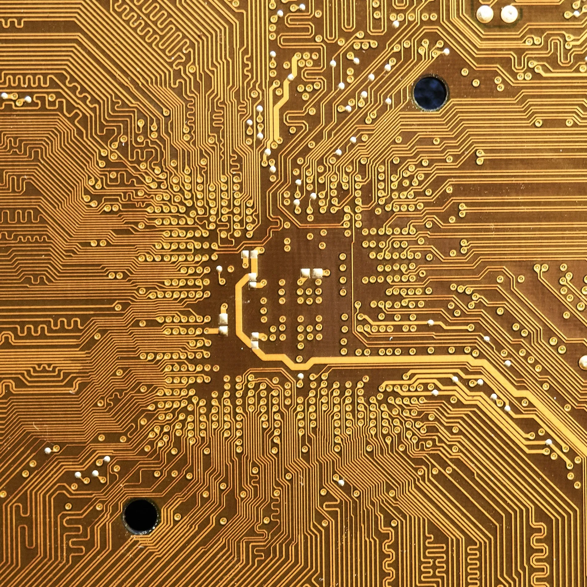 A printed circuit board, gold conductor tracks running across it